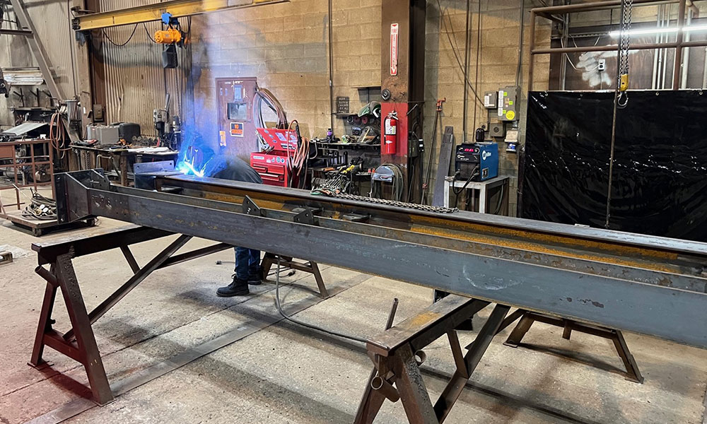 view of Yoe team working on steel in shop